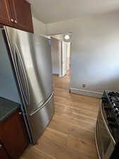 Unit 2 Kitchen featuring light hardwood / wood-style flooring and appliances with stainless steel finishes