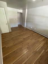 Unit 2 bedroom #2 featuring wood-type flooring and a baseboard radiator