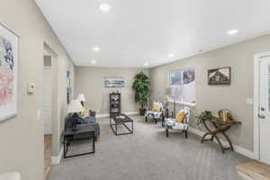 Living area featuring light colored carpet