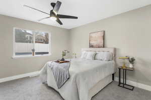 Carpeted bedroom with ceiling fan