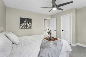 Carpeted bedroom featuring ceiling fan