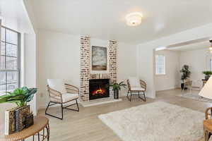 Sitting room featuring a fireplace and light hardwood / wood-style flooring