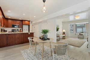 Dining area featuring sink and light hardwood / wood-style floors