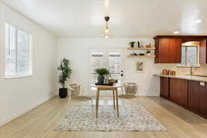 Dining room featuring sink, light hardwood / wood-style floors, and a wealth of natural light