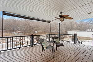 Snow covered deck featuring ceiling fan