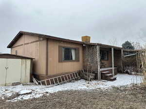 View of snow covered rear of property