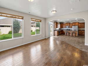 Oversized living room featuring sink and light hardwood / wood-style floors