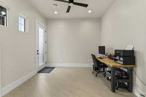 Office space with ceiling fan and light wood-type flooring