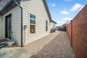 View of side of home featuring central AC