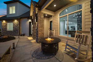 Patio terrace at dusk featuring a fire pit