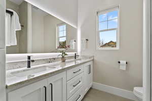 Bathroom featuring dual vanity and extra storage.