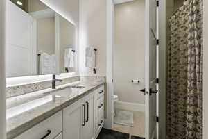 Bathroom featuring vanity, hardwood / wood-style floors, and toilet