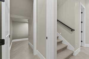 Staircase featuring hardwood / wood-style floors