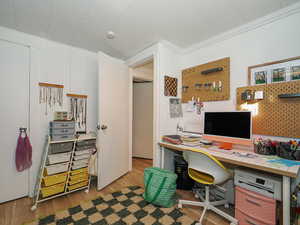 Home office featuring crown molding and light hardwood / wood-style flooring