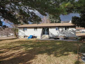 Rear view of house with a yard, outdoor lounge area, and a patio