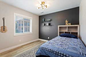 Bedroom featuring wood-type flooring