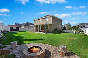 Rear view of house featuring an outdoor fire pit, a yard, a pergola, a shed, and a patio area