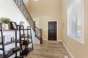 Entrance foyer featuring a high ceiling and light wood-type flooring