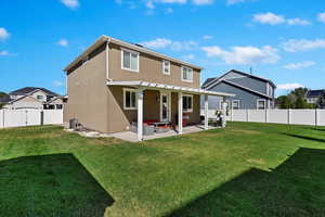 Back of house with a yard, a patio area, and a pergola