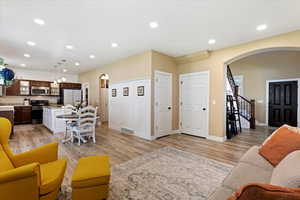 Living room with sink and light wood-type flooring