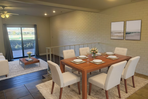 Dining area featuring dark hardwood / wood-style flooring and brick wall