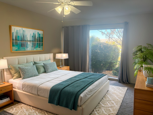 Bedroom featuring ceiling fan and carpet