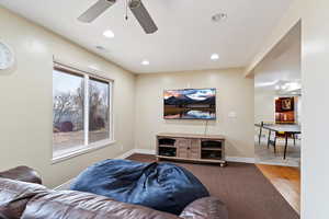 Living room featuring hardwood / wood-style floors and ceiling fan