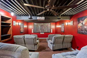 Cinema featuring carpet floors and baseboards