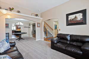 Living room featuring crown molding and carpet floors