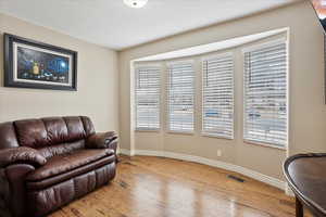 Sitting room featuring hardwood / wood-style floors