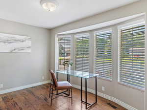 Home office featuring wood finished floors and baseboards