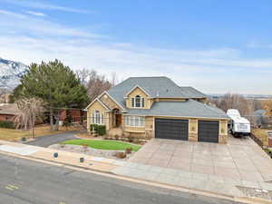 View of front facade with a garage and a mountain view