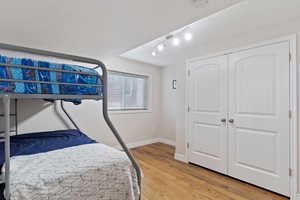 Bedroom featuring light hardwood / wood-style floors and a closet