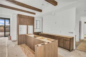 Kitchen featuring beam ceiling and a center island