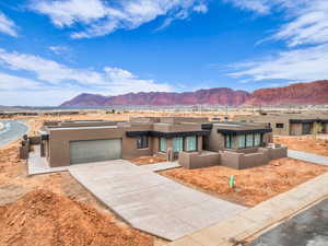 Pueblo revival-style home featuring a mountain view and a garage