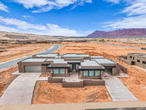 View of front facade with a garage and a mountain view