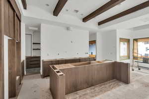 Kitchen with beam ceiling and a kitchen island