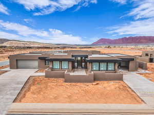 View of front of home featuring a garage and a mountain view