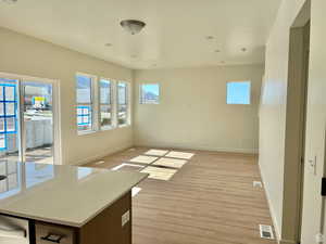 Empty room with light hardwood / wood-style floors NOT EXACT HOME