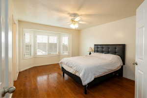 Primary Bedroom featuring dark hardwood / wood-style floors and ceiling fan