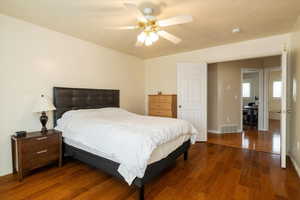 Primary Bedroom featuring ceiling fan and dark hardwood / wood-style flooring