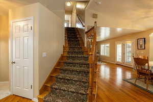 Staircase featuring hardwood / wood-style floors