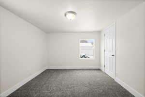 Empty room with carpet and a textured ceiling