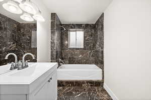 Bathroom featuring vanity and tiled shower / bath combo