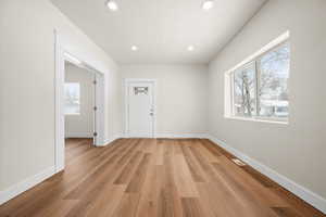 Empty room featuring light hardwood / wood-style flooring and a textured ceiling