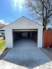 Detached garage featuring fence
