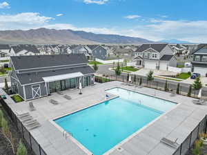 View of pool with a mountain view and a patio area