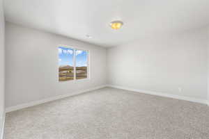 Carpeted empty room featuring a textured ceiling