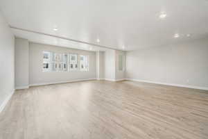 Empty room with light hardwood / wood-style floors