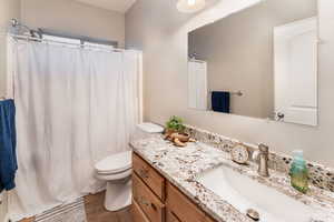 Guest bathroom featuring vanity, toilet, and bath/shower combo